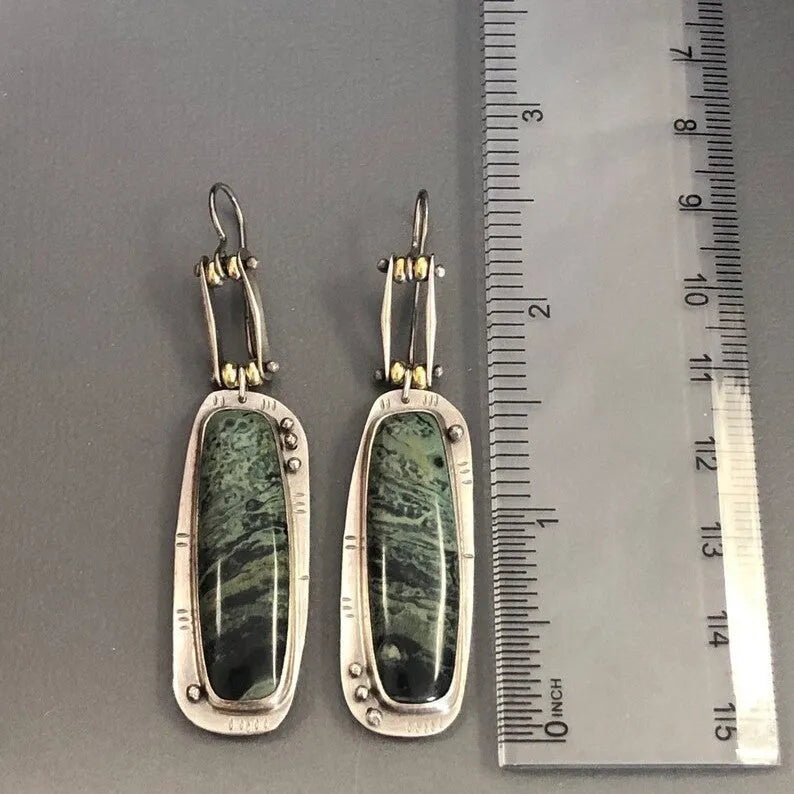 A pair of simple geometric alloy earrings with a two-tone marble pattern finish.