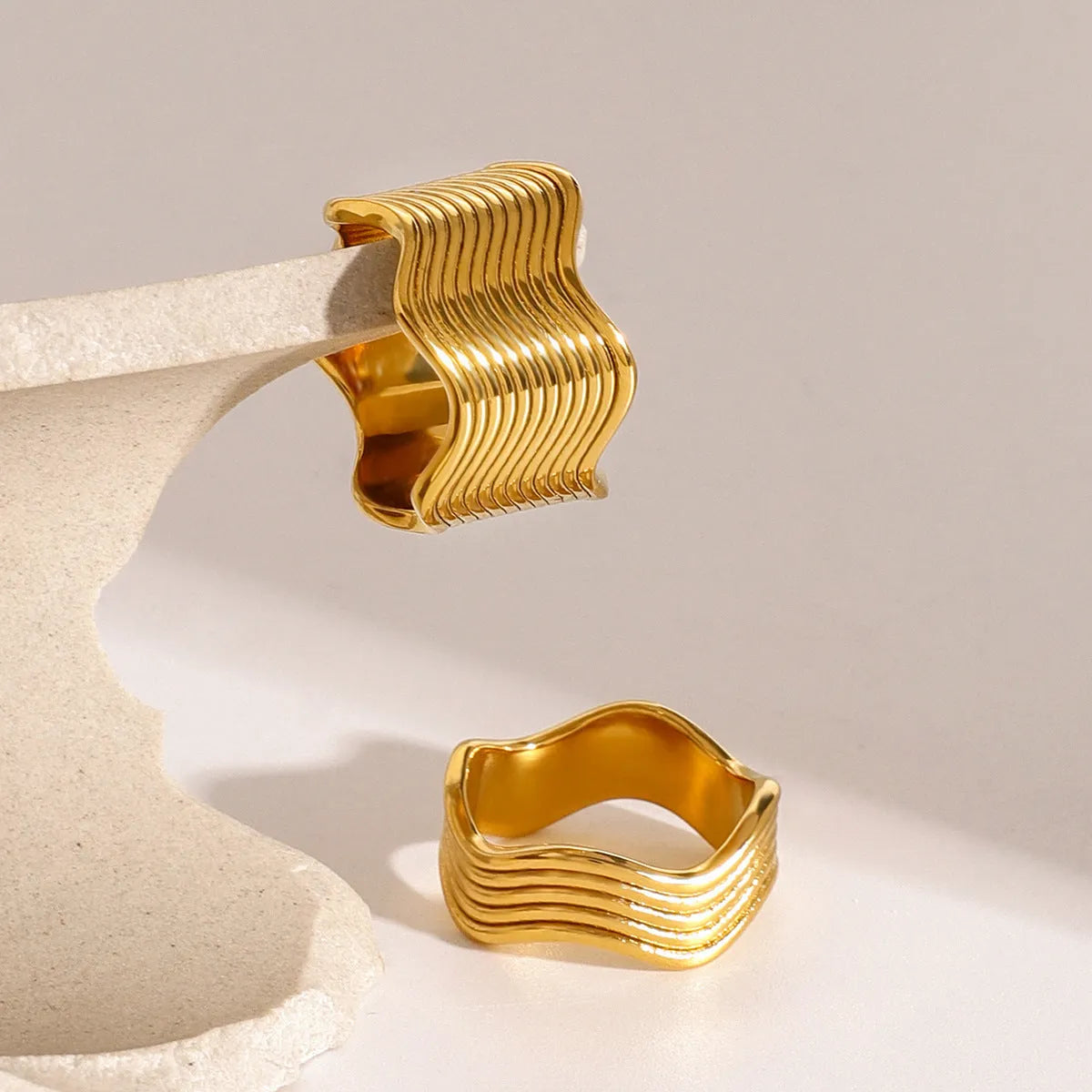 Stainless steel wide surface wave ring with geometric pattern in silver and gold tone options
