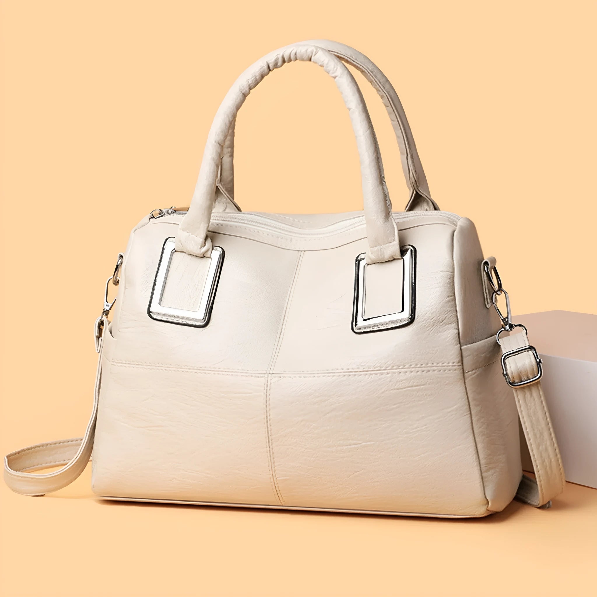 Women's large capacity square shoulder bag in neutral colour with interior phone and file pockets.