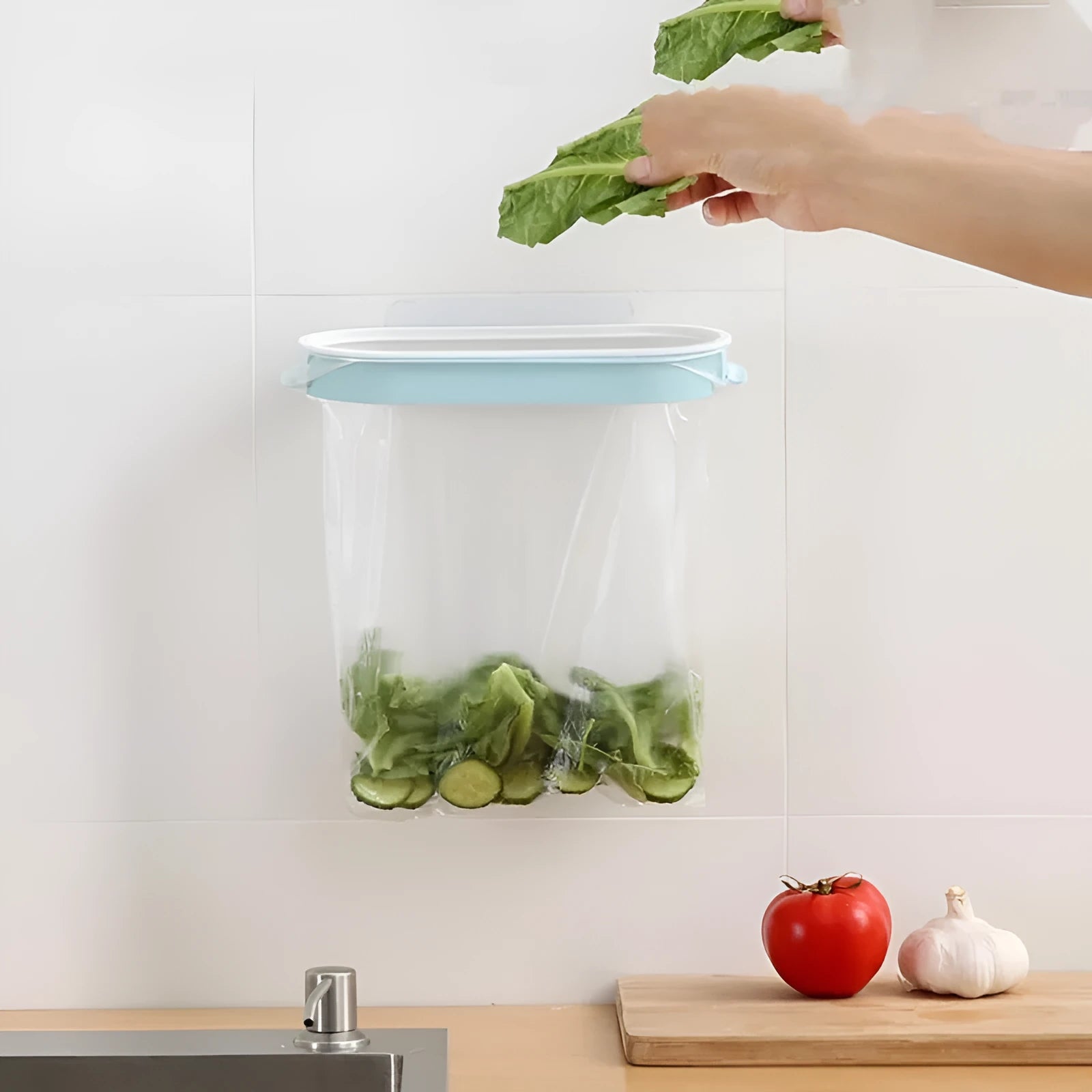 Blue plastic kitchen bin bag storage rack mounted under sink with removable shelf