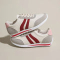 Red and blue lace-up low-top running sneakers with a PU mesh upper and flat rubber sole.