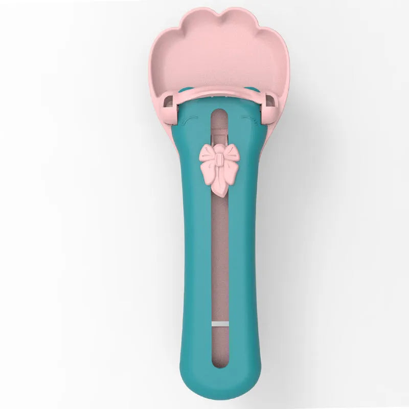 Green and pink pet food squeezer feeder scoop for cats and dogs.