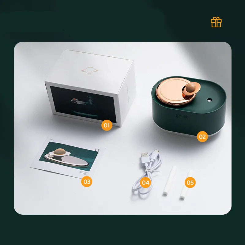 Green rotating planet-shaped USB humidifier with night light on a desk.