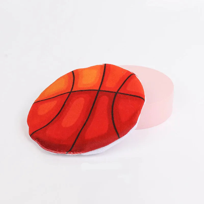 Small, flat, plush flying disc cat toy with a sport ball pattern, containing catnip and a crinkle sound element.