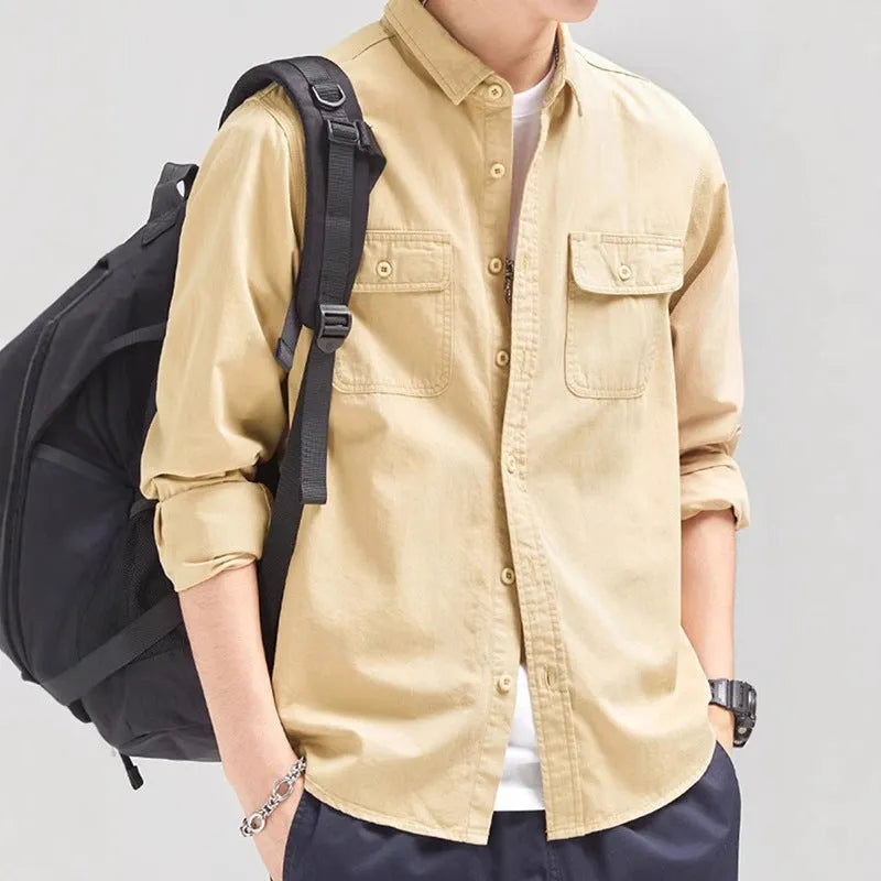 A man wearing a loose fit light grey long sleeve polyester cardigan shirt