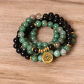Green and black alloy elastic beaded bracelet with charm decorations on a stretch band.