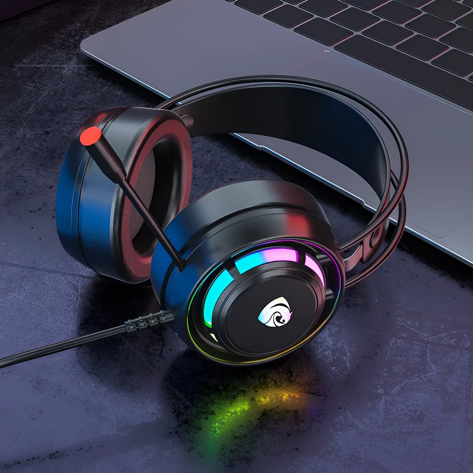 Black wired over-ear computer headphones with microphone and long cable on a desk