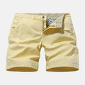 Men's loose fit printed denim shorts in blue, shown in a casual setting.