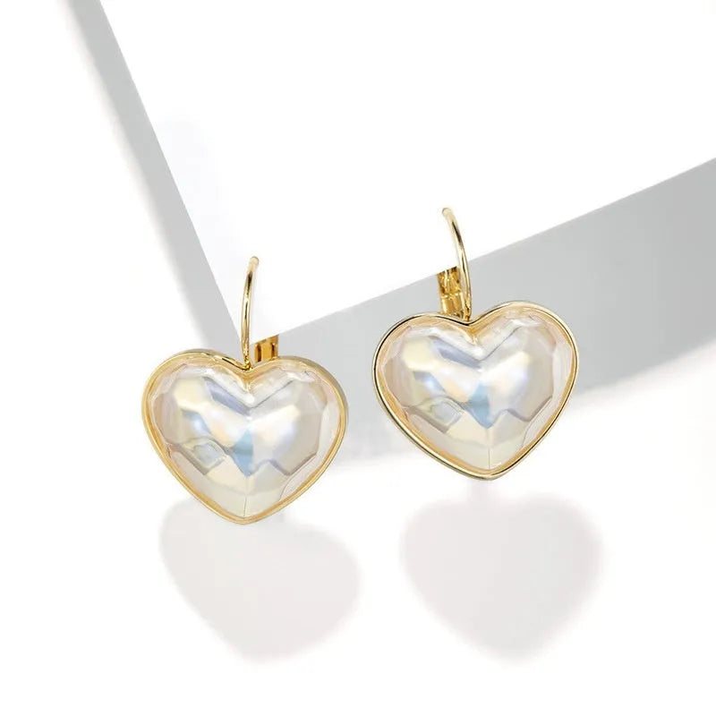 A pair of gold-coloured alloy ear clips for women in a natural style.