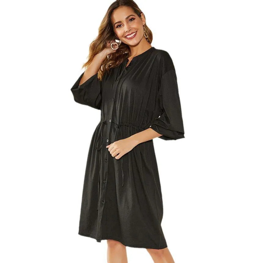 Black polyester A-line midi dress with elastic waist and long sleeves displayed front view