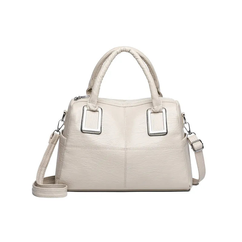 Women's large capacity square shoulder bag in neutral colour with interior phone and file pockets.