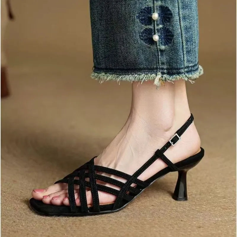 Retro-style women's sandals with thin cross straps, an ankle buckle, and a square toe in a light brown colour.