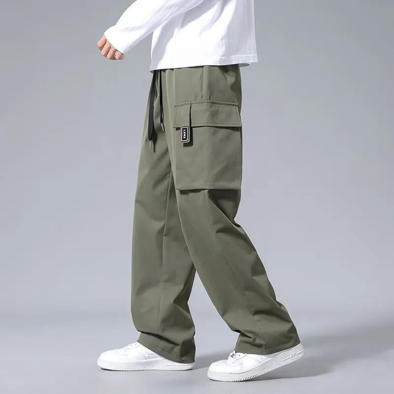 Boys straight cargo pants in army green with large side pockets and drawstring waist on white background