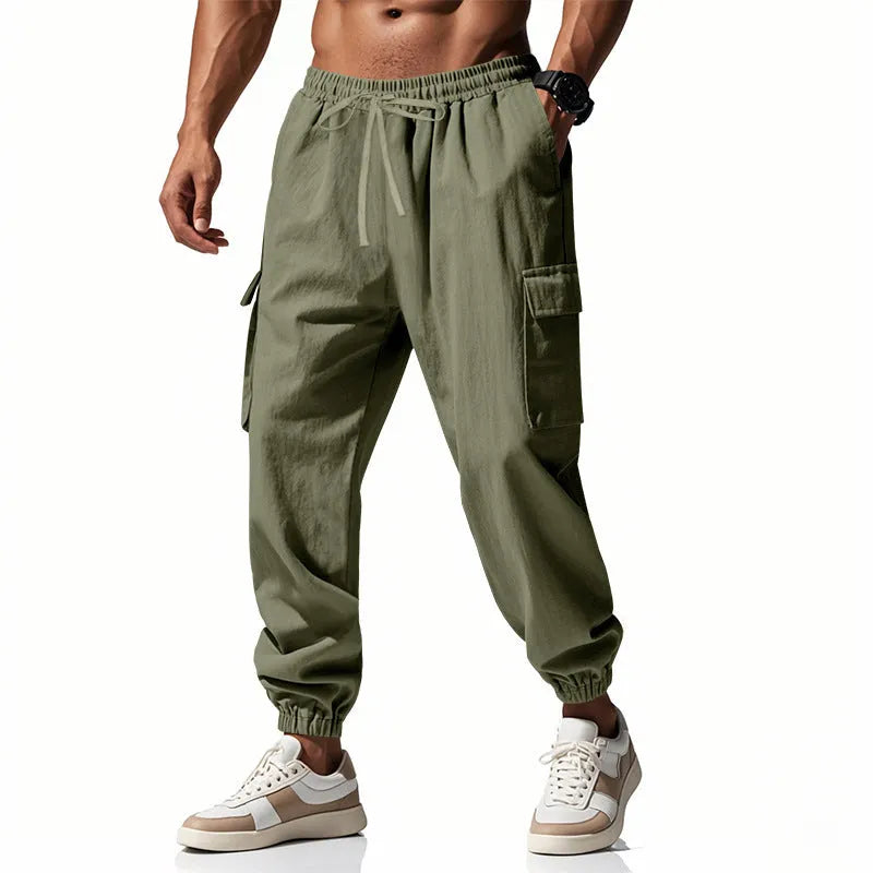 Men's loose linen trousers in Army Green with ankle ties and a multi-pocket tether detail.