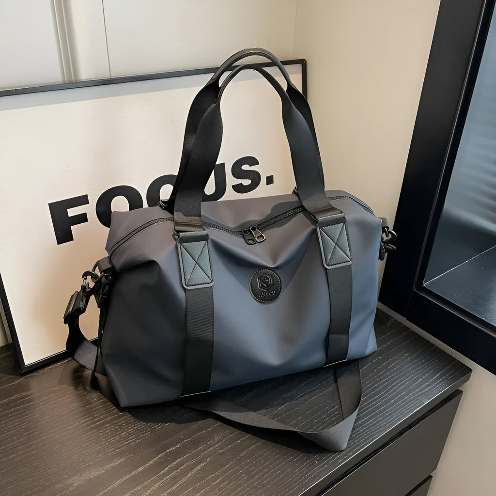 Oxford cloth travel bag in black with 36-55 litre capacity showing breathable back panel and organisational compartments