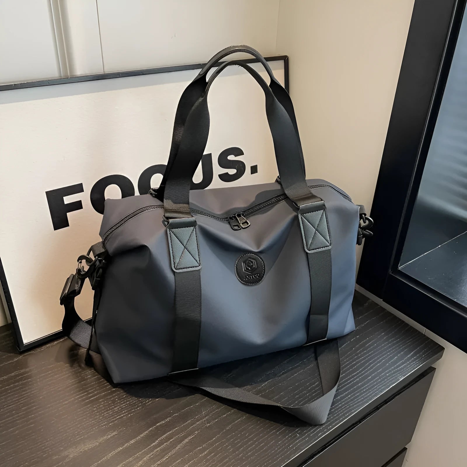 Oxford cloth travel bag in black with 36-55 litre capacity showing breathable back panel and organisational compartments
