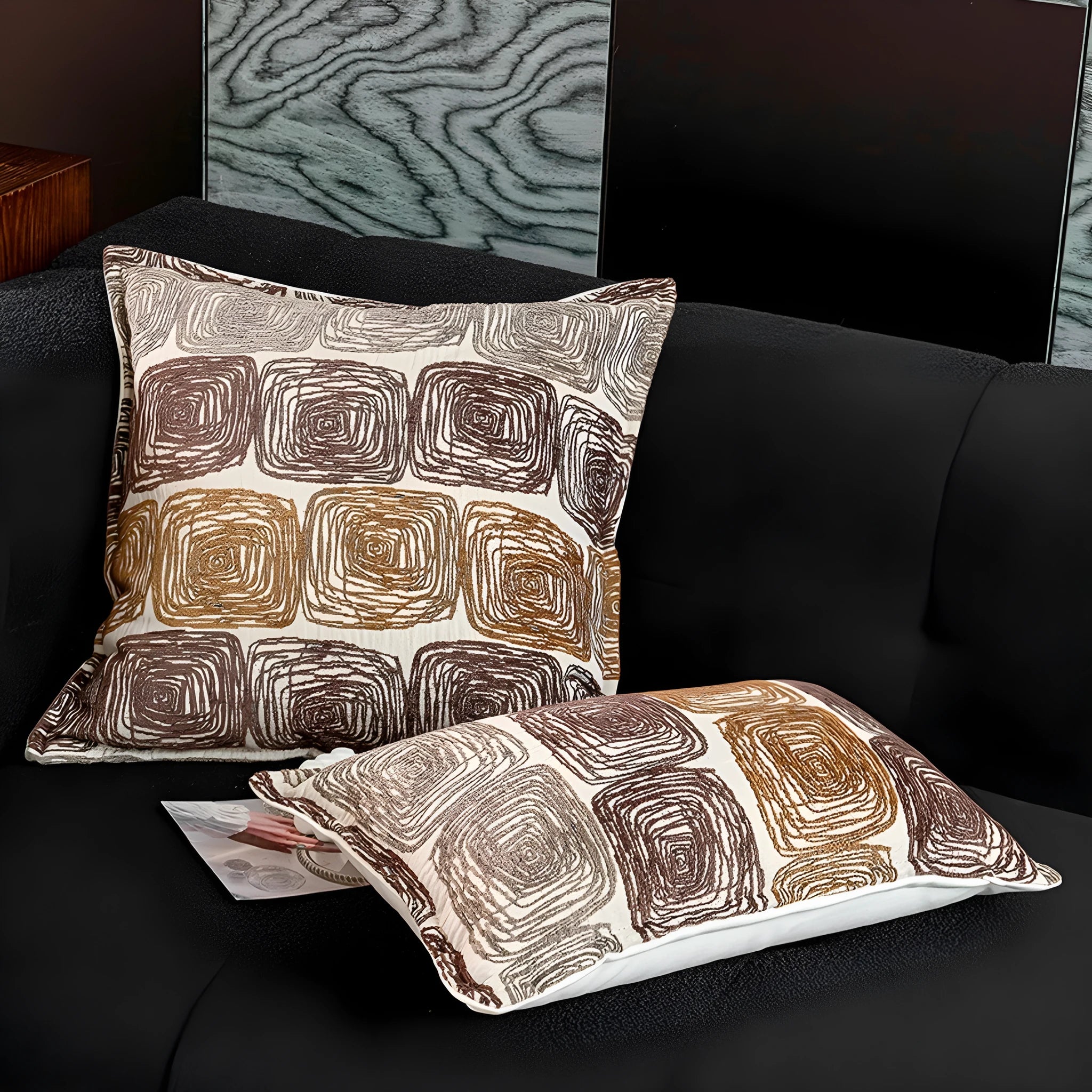 Abstract coil pattern cushion cover in cream and coffee colours, shown in square and rectangular sizes