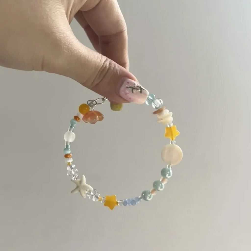 Orange alloy bracelet with diamond shape and round mixed material elements