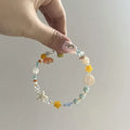 Orange alloy bracelet with diamond shape and round mixed material elements