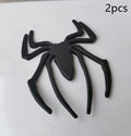 Three-dimensional metal spider bumper sticker in silver finish, measuring 7cm by 5cm.