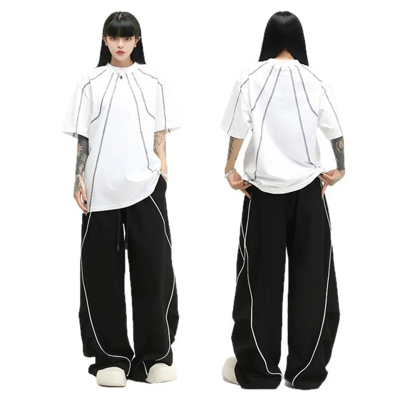 Black pleated hip hop sports pants with stripe pattern showing wide-leg design and mid-waist fit