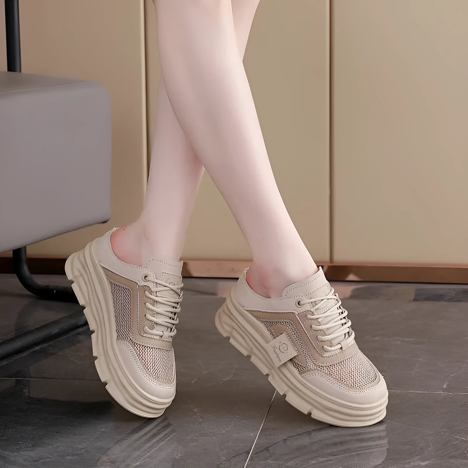 Women's black mesh half slippers with round toe and rubber sole, shown on a foot.