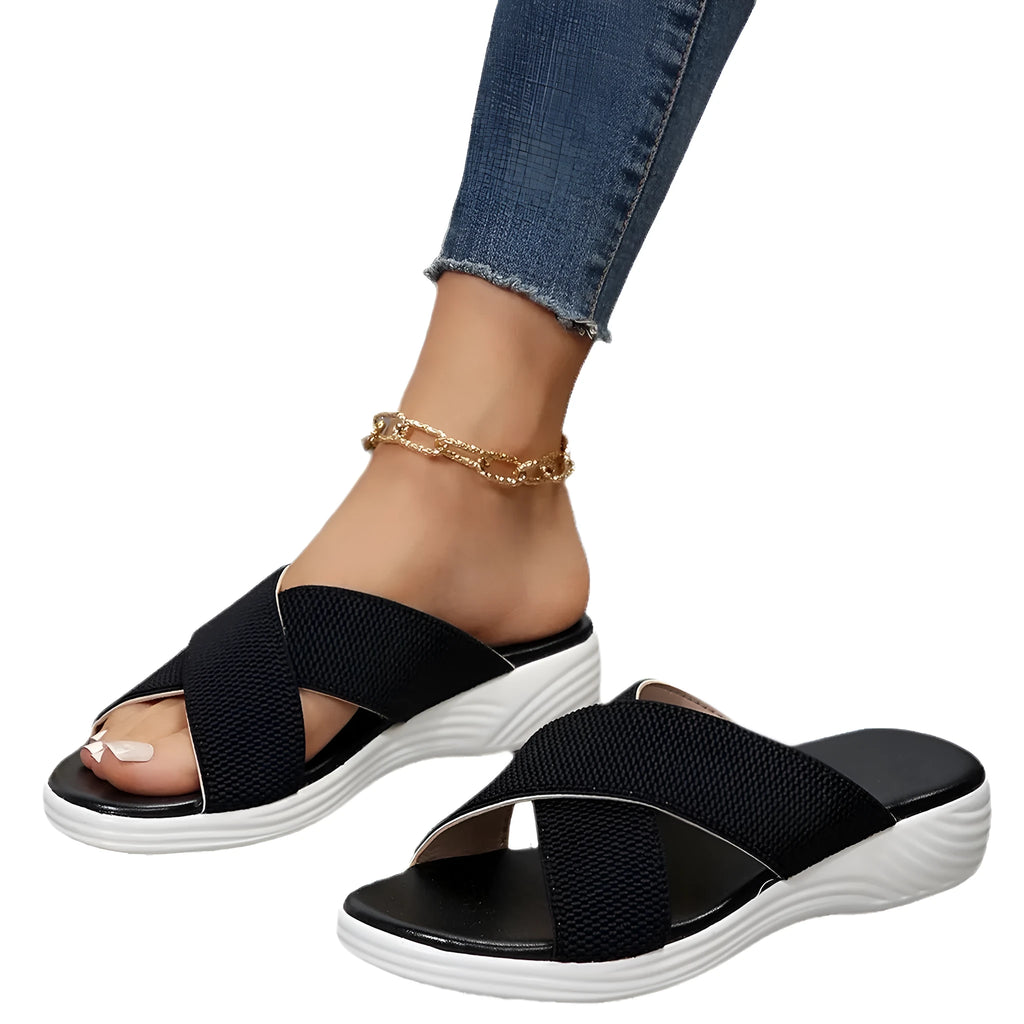 Women's black peep-toe wedge slippers with a thick rubber sole and fish mouth design on a white background.