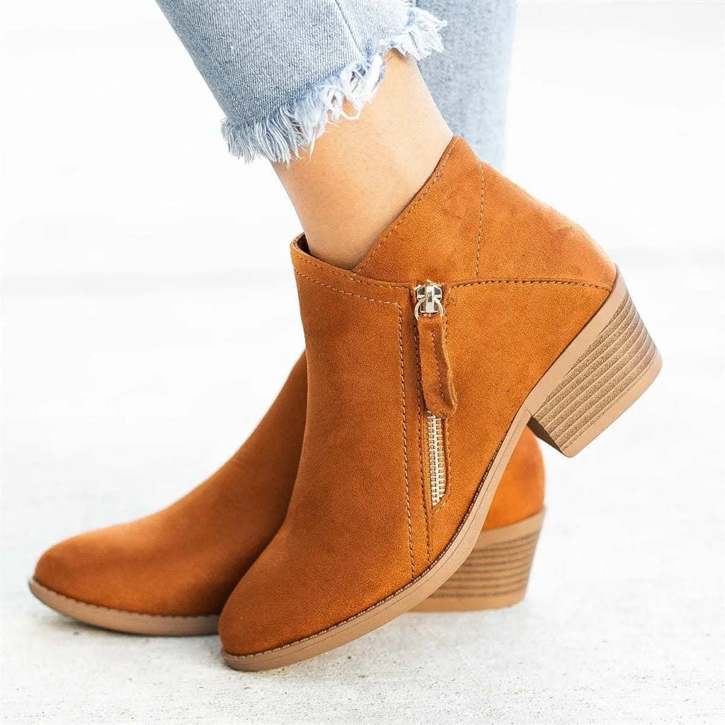 Blue women's suede ankle boots with a side zipper closure and a lightweight composite sole.