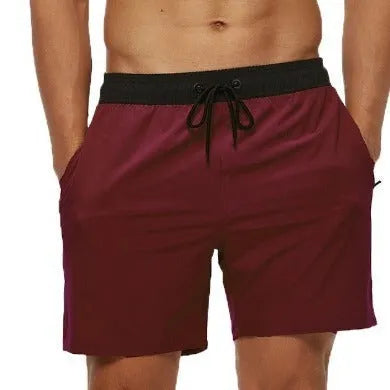 Men's blue running shorts with a drawstring waist and a zippered side pocket.