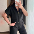 Woman wearing a loose-fitting white damascus-pattern short sleeve polyester casual shirt.