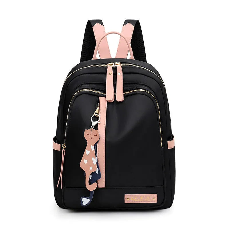 Black women's casual nylon backpack with soft handle and shoulder straps showing internal compartments