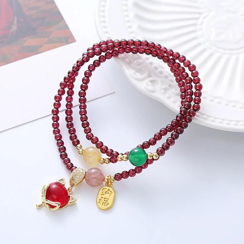 Natural crystal fox bracelet for women with purplish red garnet pendant on adjustable rope