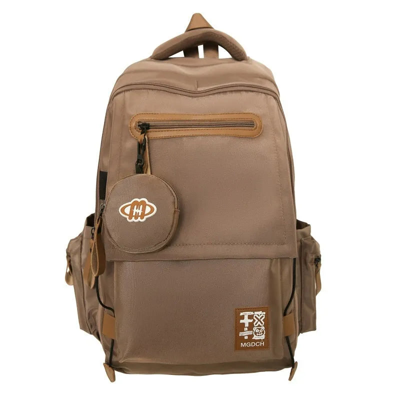 Large-capacity nylon backpack for middle school students in solid colour with curved shoulder strap and sewing line detail