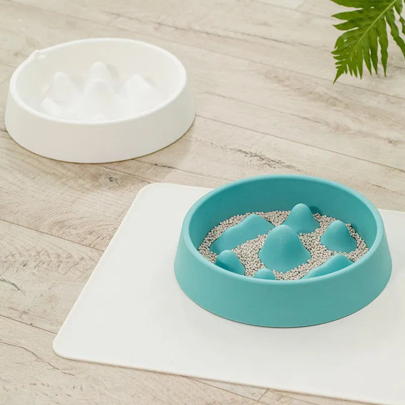 Pet slow food bowl with raised mountain bumps in off-white colour on a floor mat