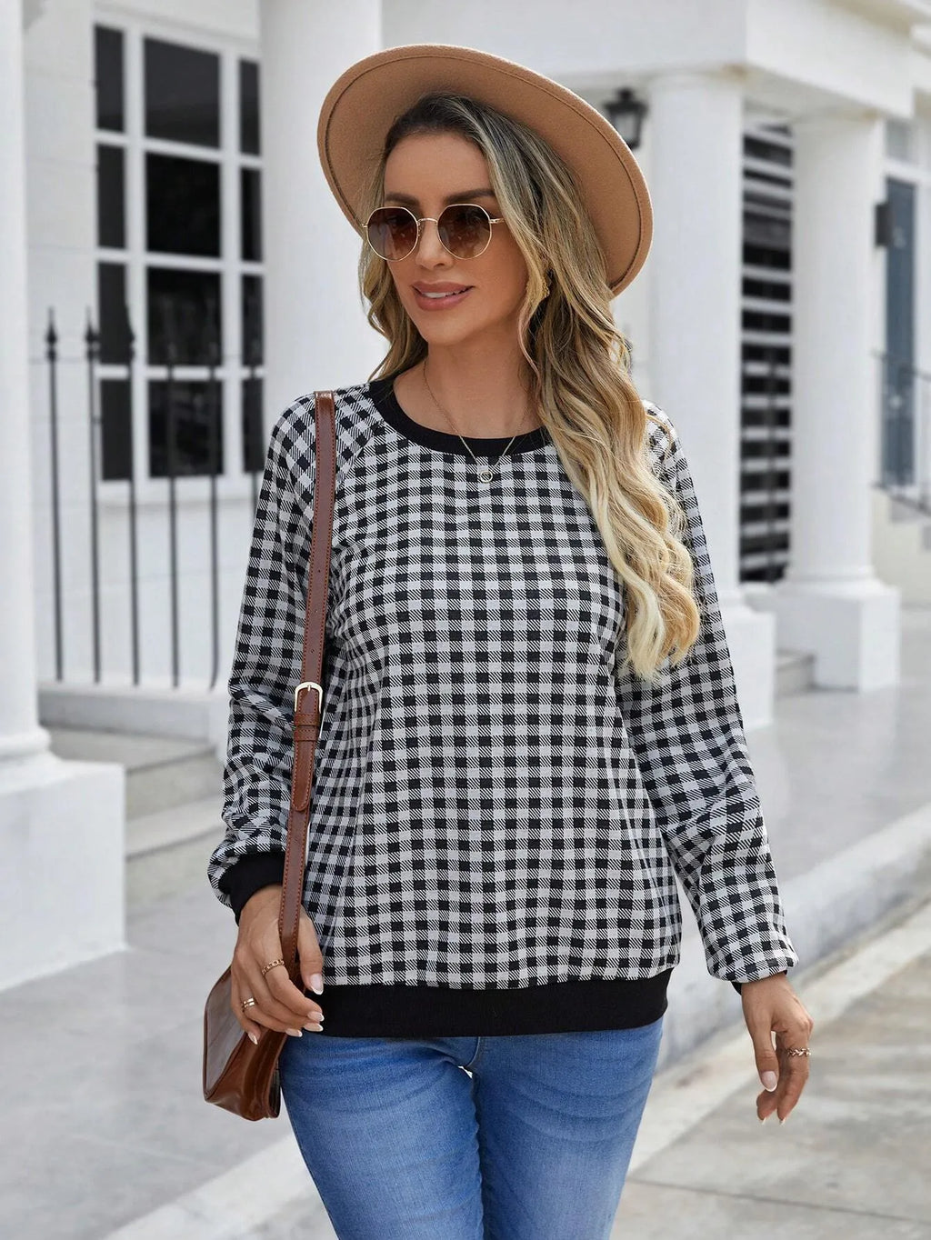 Black long sleeve pullover sweater with printed plaid and stripe pattern design.