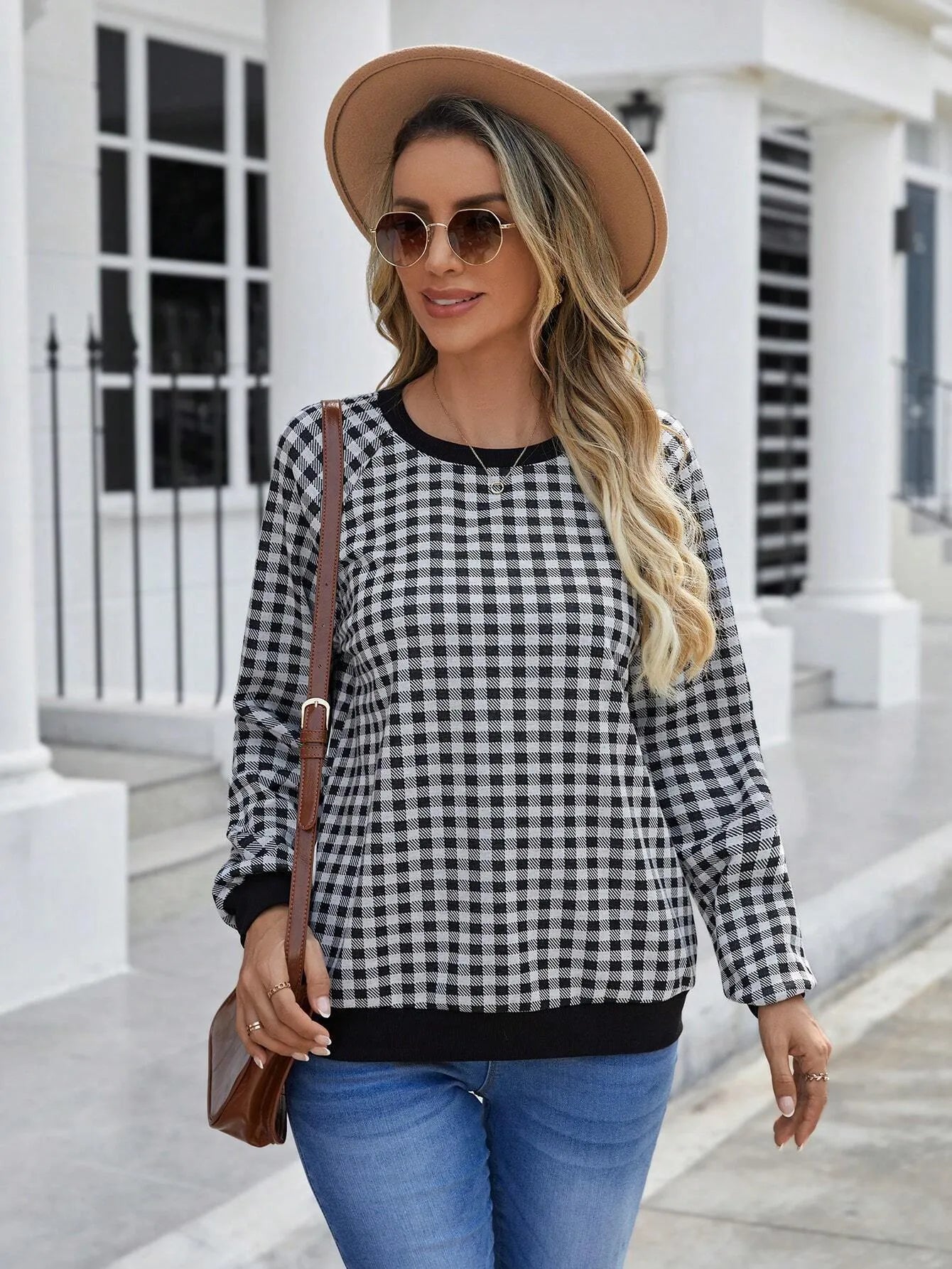 Black long sleeve pullover sweater with printed plaid and stripe pattern design.