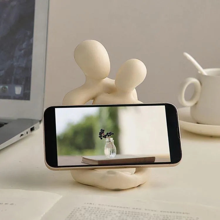 Modern resin sculpture of an embracing couple, available in milky white or gold, for shelf or desk decor.