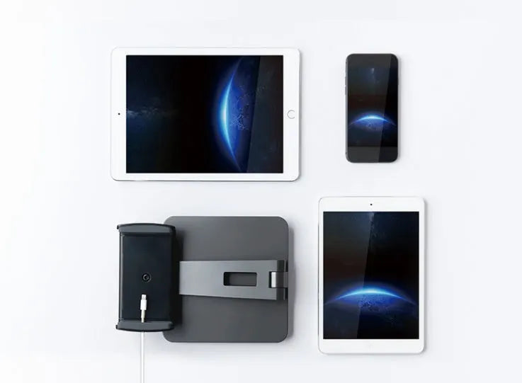 Silver folding aluminium phone and tablet stand with 360° rotation on wooden desk