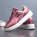 Sequin platform sneakers with thick sole in rose gold colour showing round toe and decorative stitching