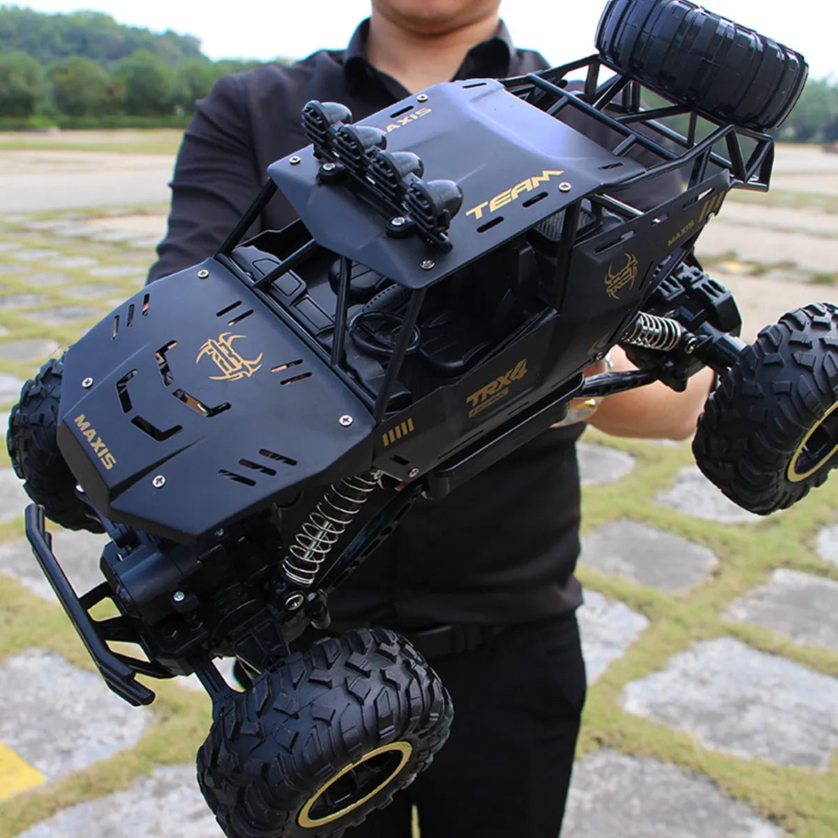 Large black 2.4G remote control four-wheel drive off-road climbing car on rough terrain