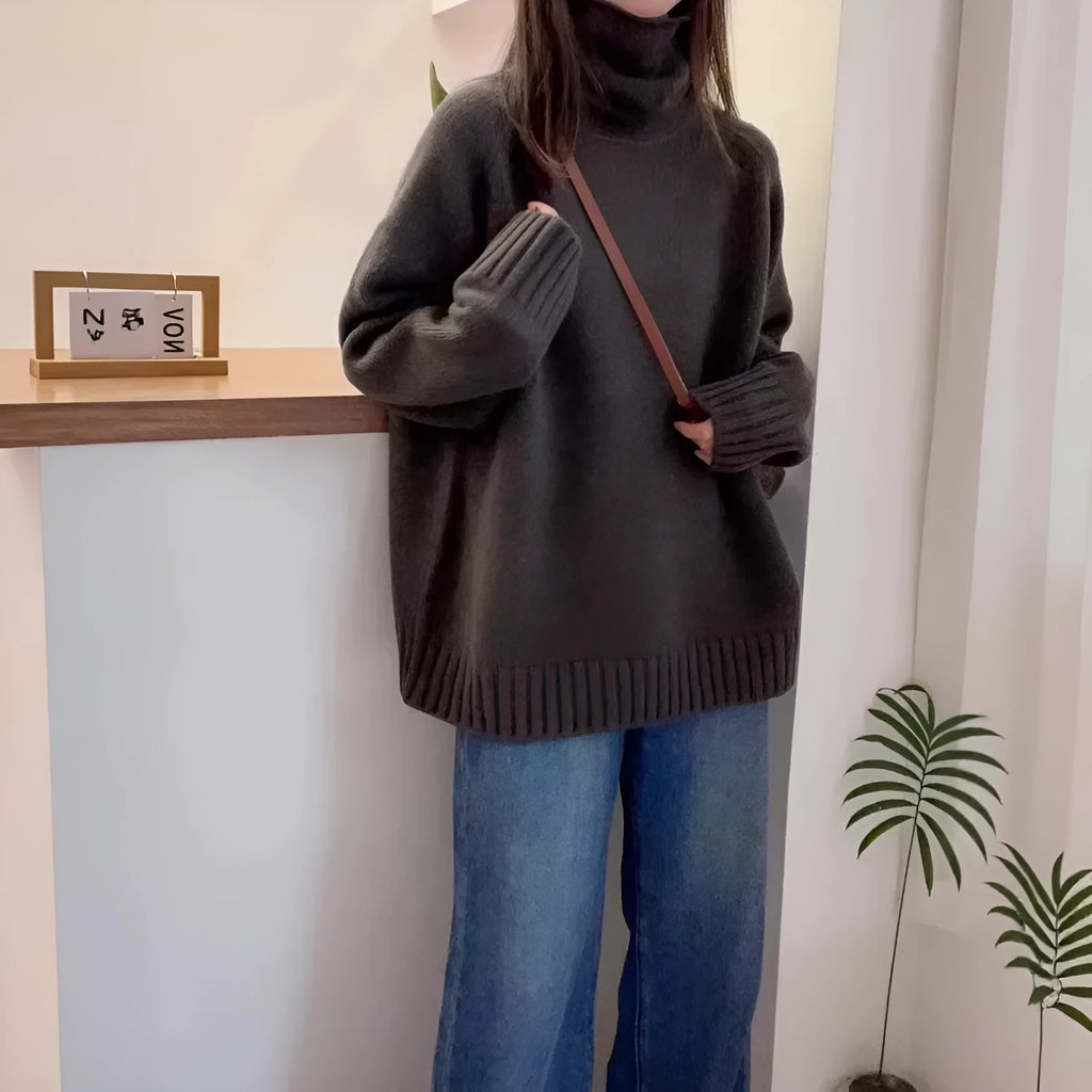 Women's loose turtleneck sweater with thick curling pile collar in red, camel, grey, or black.