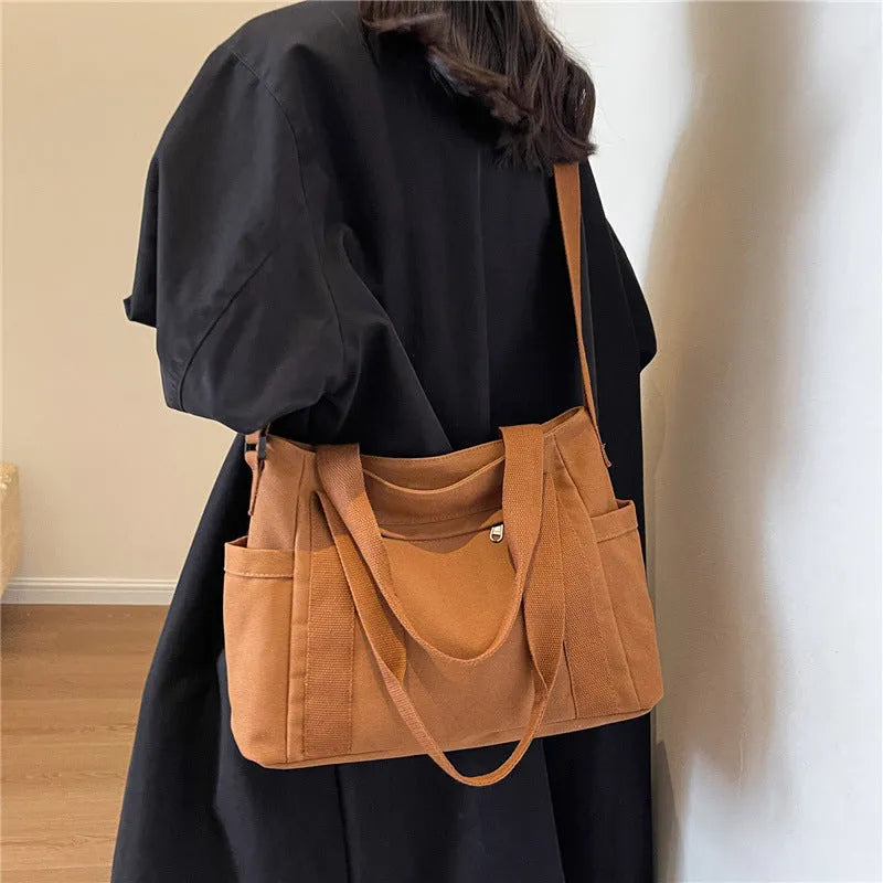 Polyester canvas shoulder bag in solid colour with internal mobile phone pocket organisation