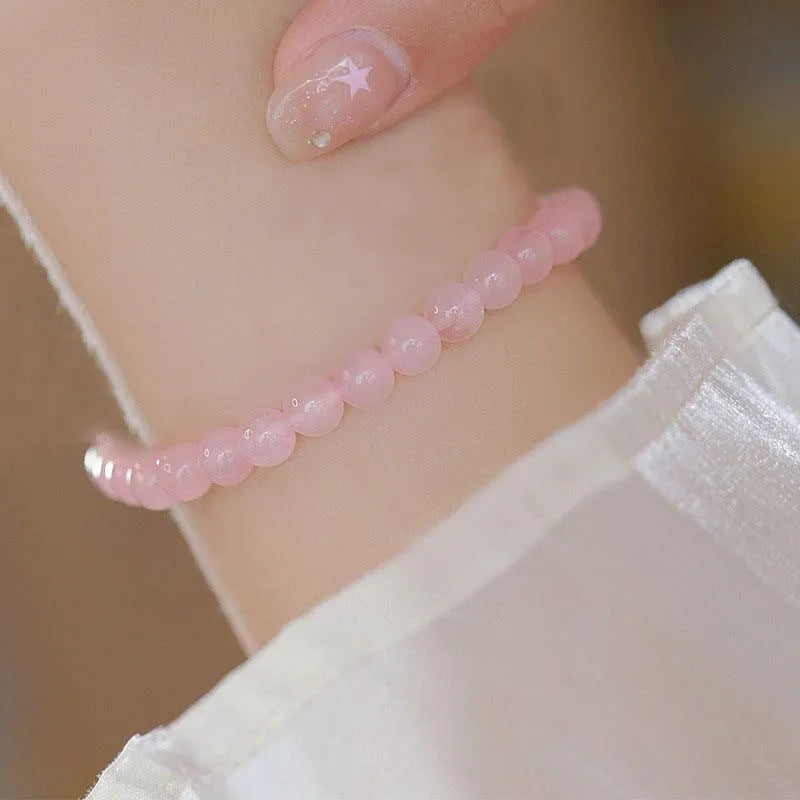 Women's aquamarine crystal bracelet with round geometric beads in mixed materials including natural pink crystal and imitation pearl