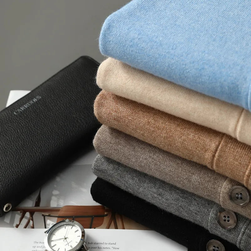 Man wearing a beige loose-fit V-neck Andy velvet knitted cardigan coat with long sleeves.