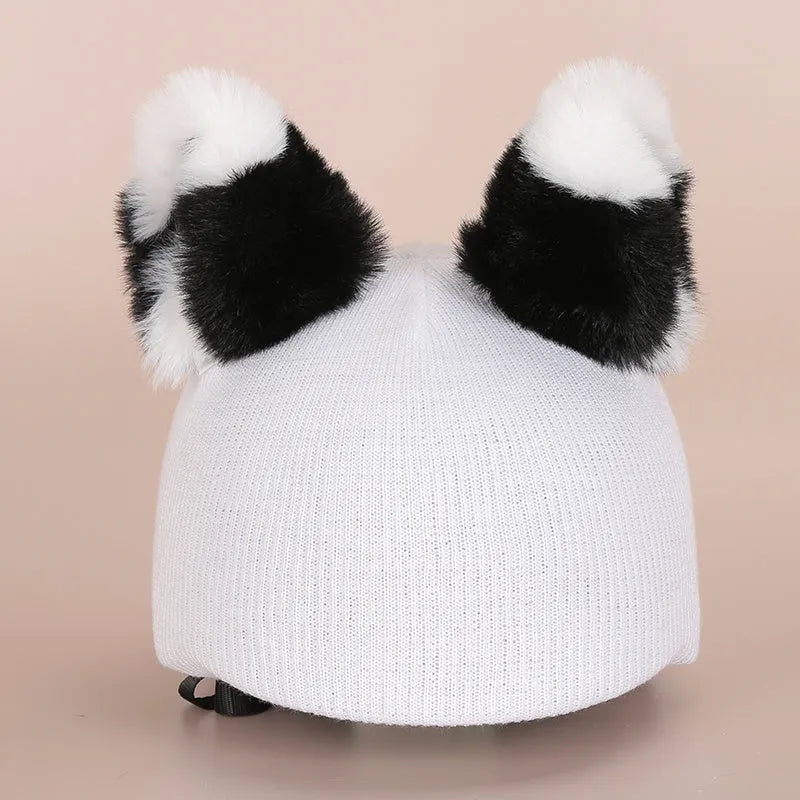 Soft plush cartoon decoration cap placed on a ski helmet for personalisation.