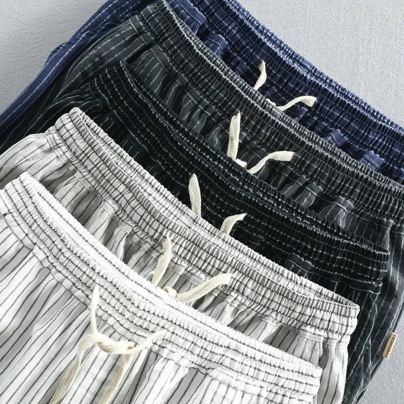 Men's striped casual loose straight shorts in cotton fabric on a hanger