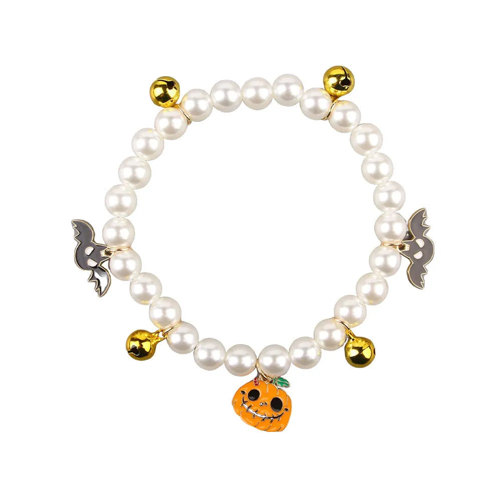 Halloween cat collar with simulated pearl necklace and a central pumpkin charm decoration.