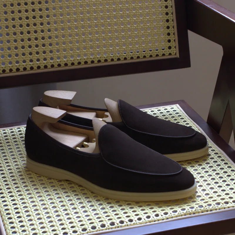 Men's handmade leather loafers in brown with TPR sole on wooden surface