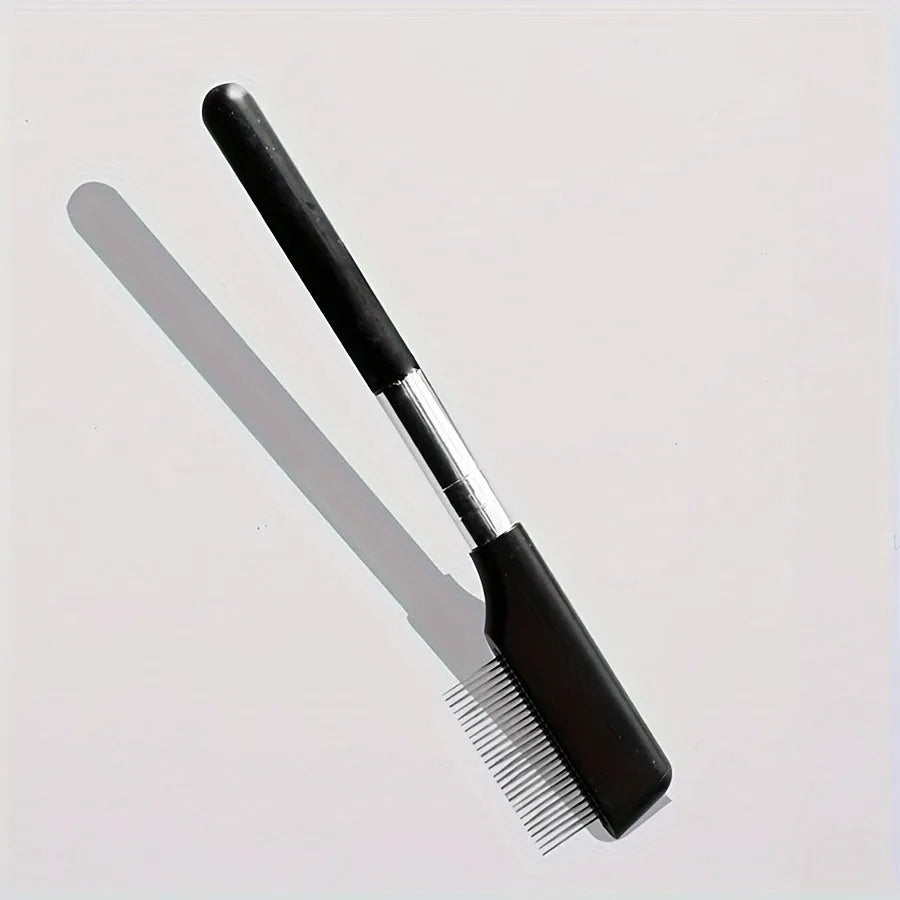 Black pet grooming brush with soft bristles and comb attachment for eye area cleaning on dogs and cats