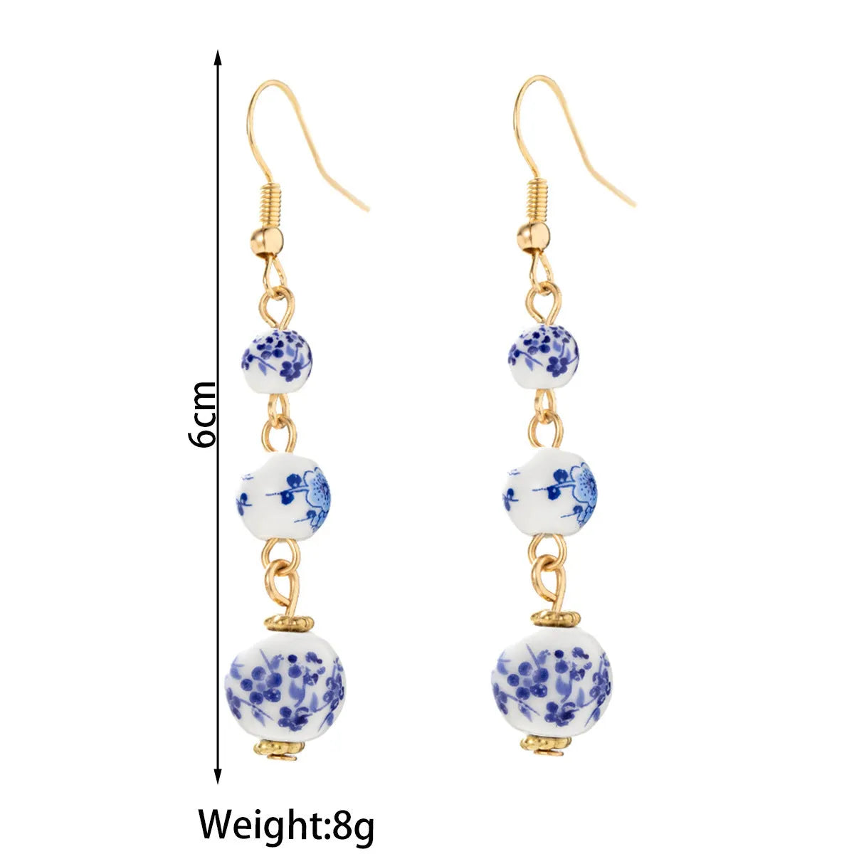 Blue and white porcelain ceramic beads long drop earrings on display with geometric round shape and alloy backing